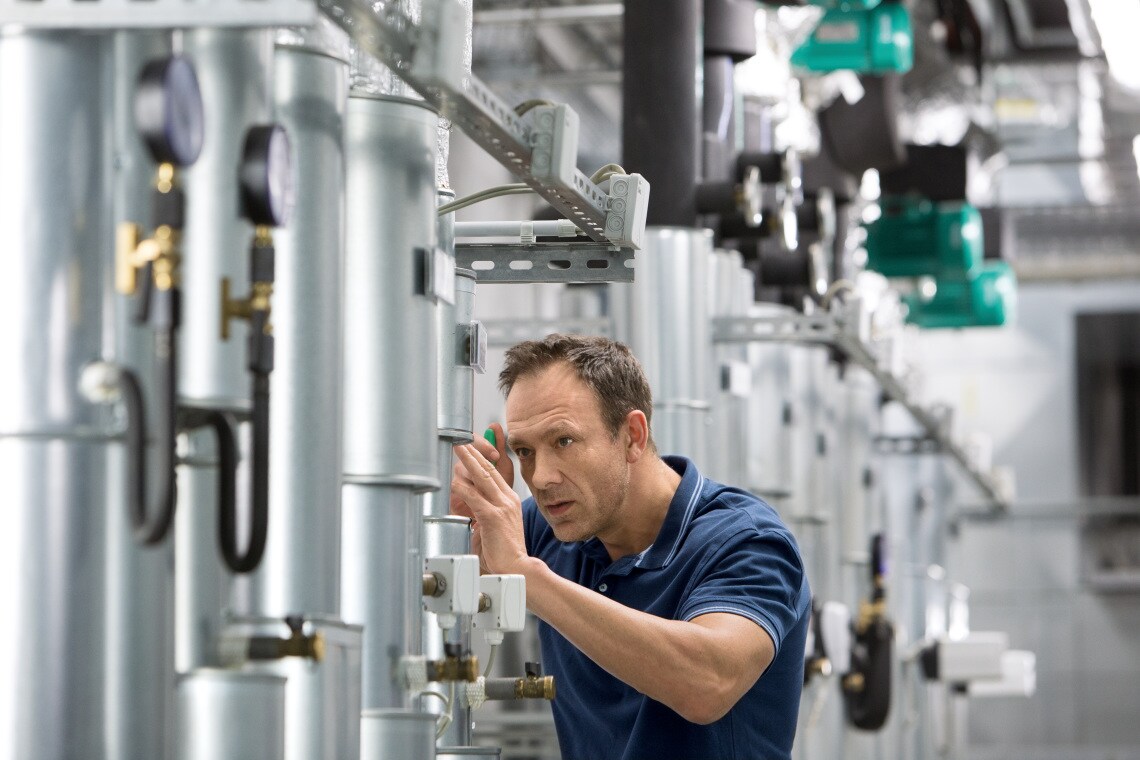 Installer Sascha working in boiler room