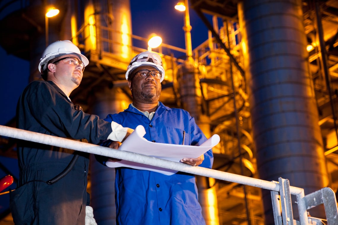 Workers at chemical plant at night