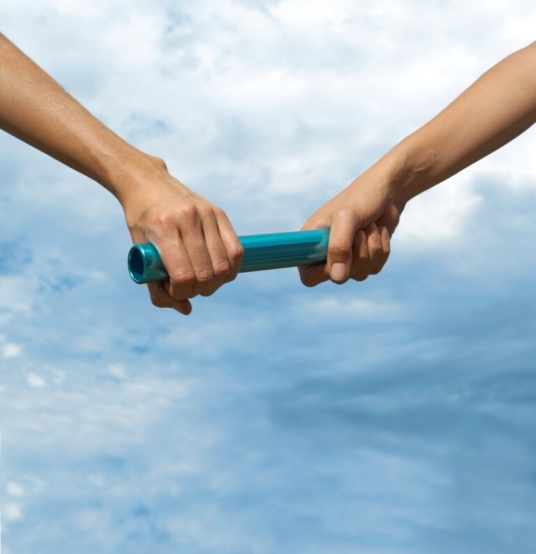 Two young women holding relay baton